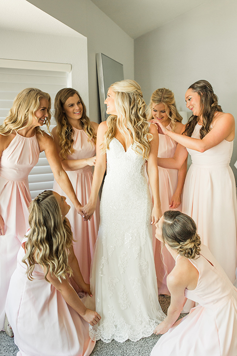 Autumn-inspired-wedding-at-coto-valley-country-club-bride-with-bridesmaids-fixing-dress