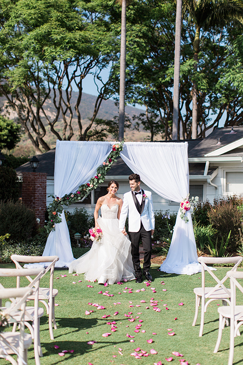 Santa-barbara-outdoor-wedding-bride-and-groom-ceremony-holding-hands-smiling