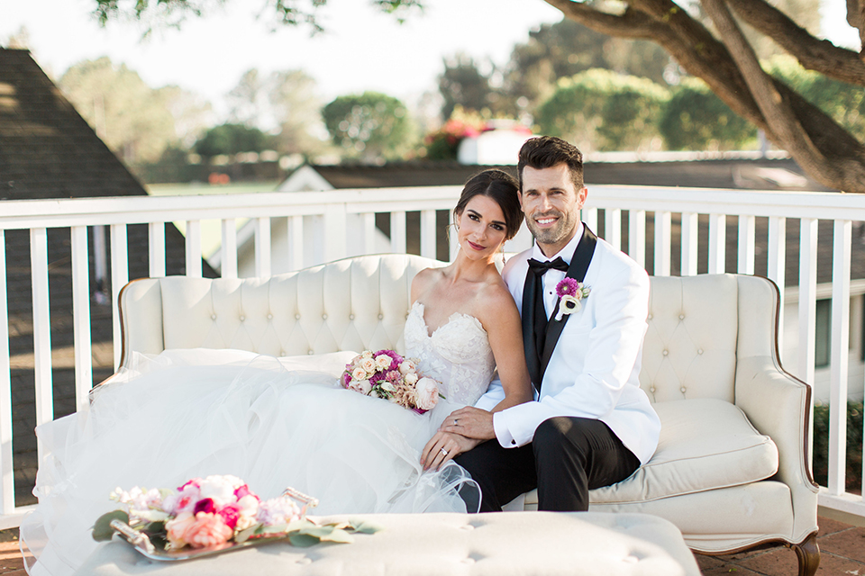 Santa-barbara-outdoor-wedding-bride-and-groom-sitting-smiling