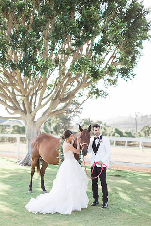 Santa-barbara-outdoor-wedding-bride-and-groom-standing-by-horse-far-away