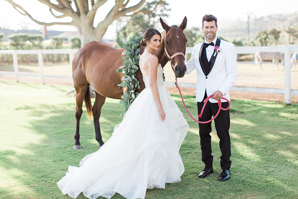 Santa-barbara-outdoor-wedding-bride-and-groom-standing-by-horse-smiling