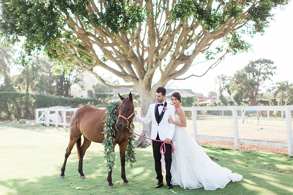 Santa-barbara-outdoor-wedding-bride-and-groom-standing-by-horse-with-flowers