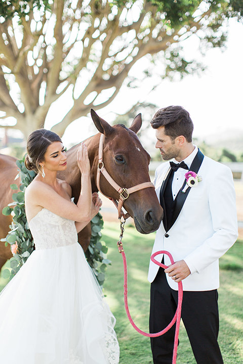 Santa-barbara-outdoor-wedding-bride-and-groom-standing-by-horse