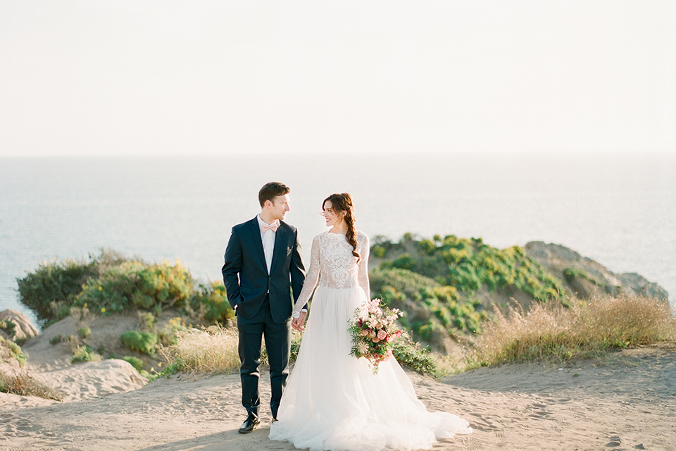 San-diego-outdoor-wedding-shoot-hawaiian-inspiration-bride-and-groom-holding-hands-smiling