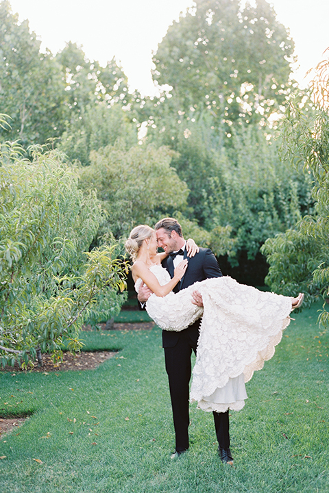 Santa-barbara-outdoor-wedding-at-kestrel-park-bride-and-groom-holding-bride