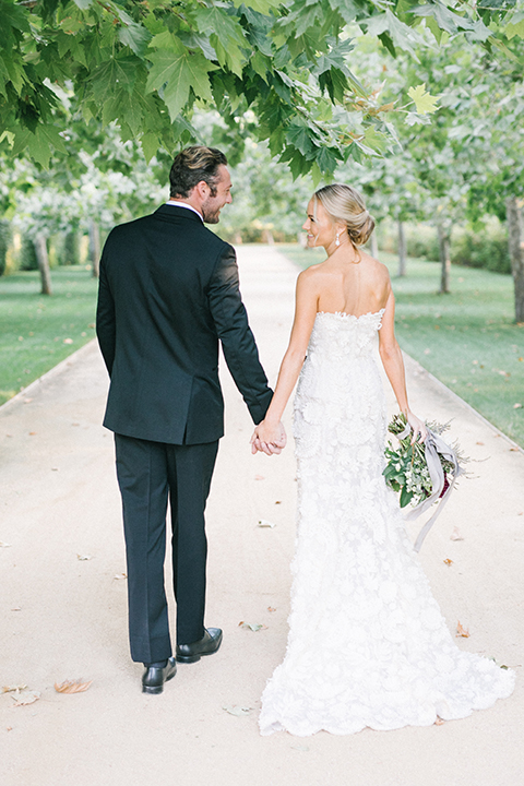 Santa-barbara-outdoor-wedding-at-kestrel-park-bride-and-groom-holding-hands-walking