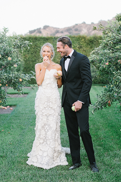 Santa-barbara-outdoor-wedding-at-kestrel-park-bride-and-groom-standing-by-tree-eating