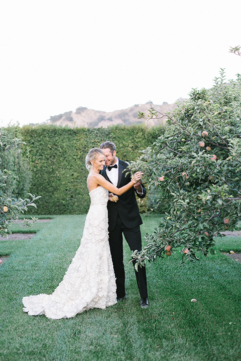 Santa-barbara-outdoor-wedding-at-kestrel-park-bride-and-groom-standing-by-tree