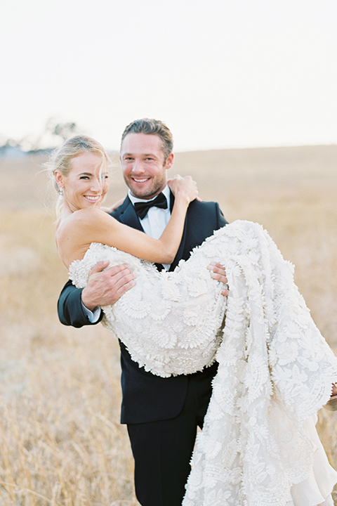 Santa-barbara-outdoor-wedding-at-kestrel-park-bride-and-groom-standing-holding-bride