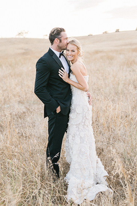 Santa-barbara-outdoor-wedding-at-kestrel-park-bride-and-groom-standing-hugging-smiling