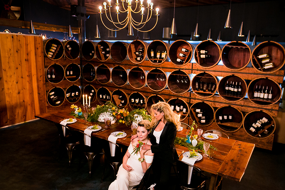 Lesbian-wedding-shoot-at-madera-kitchen-brides-sitting-at-table