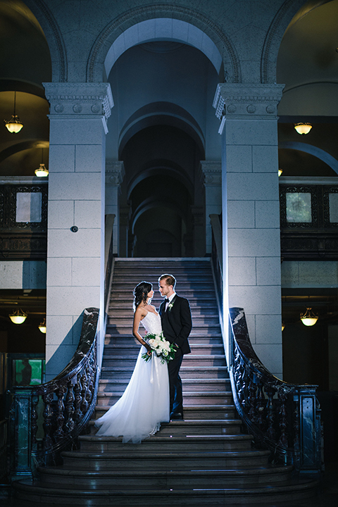 Los-angeles-wedding-at-the-majestic-bride-and-groom-standing-on-stairs-hugging