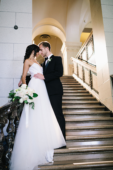 Los-angeles-wedding-at-the-majestic-bride-and-groom-standing-on-stairs-kissing