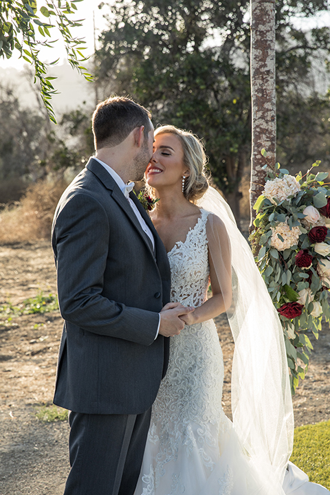 Orange-county-wedding-at-the-hamilton-oaks-winery-bride-and-groom-hugging-and-holding-hands-kissing