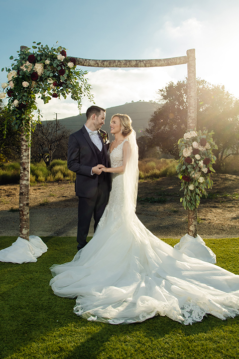 Orange-county-wedding-at-the-hamilton-oaks-winery-bride-and-groom-hugging-and-holding-hands-smiling