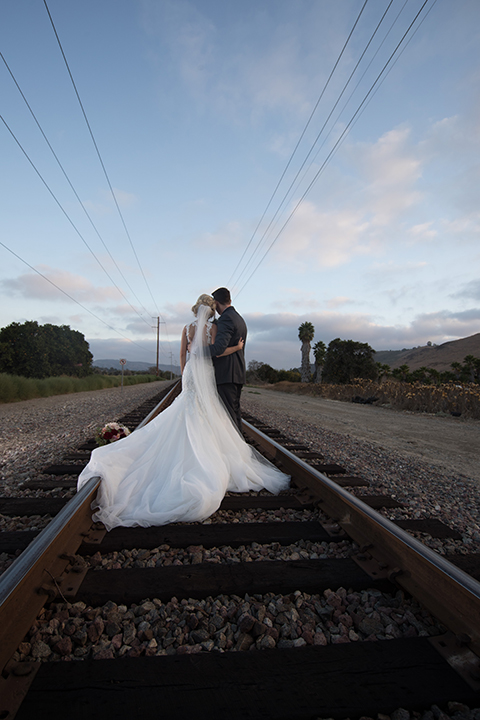 Orange-county-wedding-at-the-hamilton-oaks-winery-bride-and-groom-standing-hugging-far-away