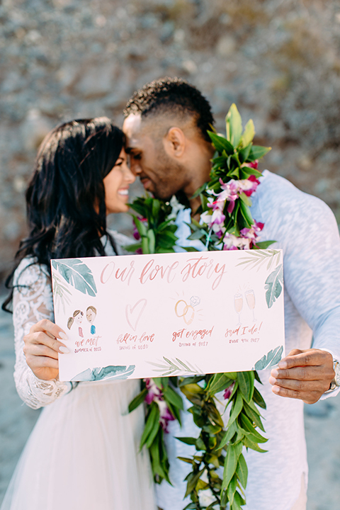 Orange-county-beach-wedding-in-dana-point-bride-and-groom-holding-sign