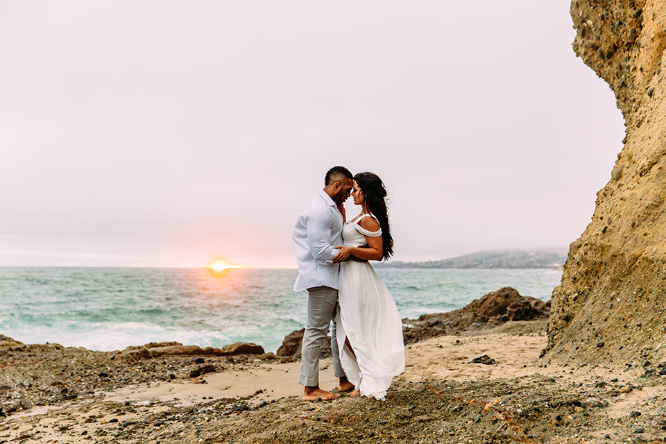 Orange-county-beach-wedding-in-dana-point-bride-and-groom-standing-and-hugging-at-sunset