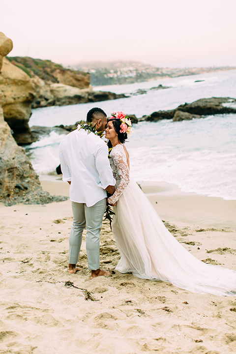 Orange-county-beach-wedding-in-dana-point-bride-and-groom-standing-holding-hands-hugging