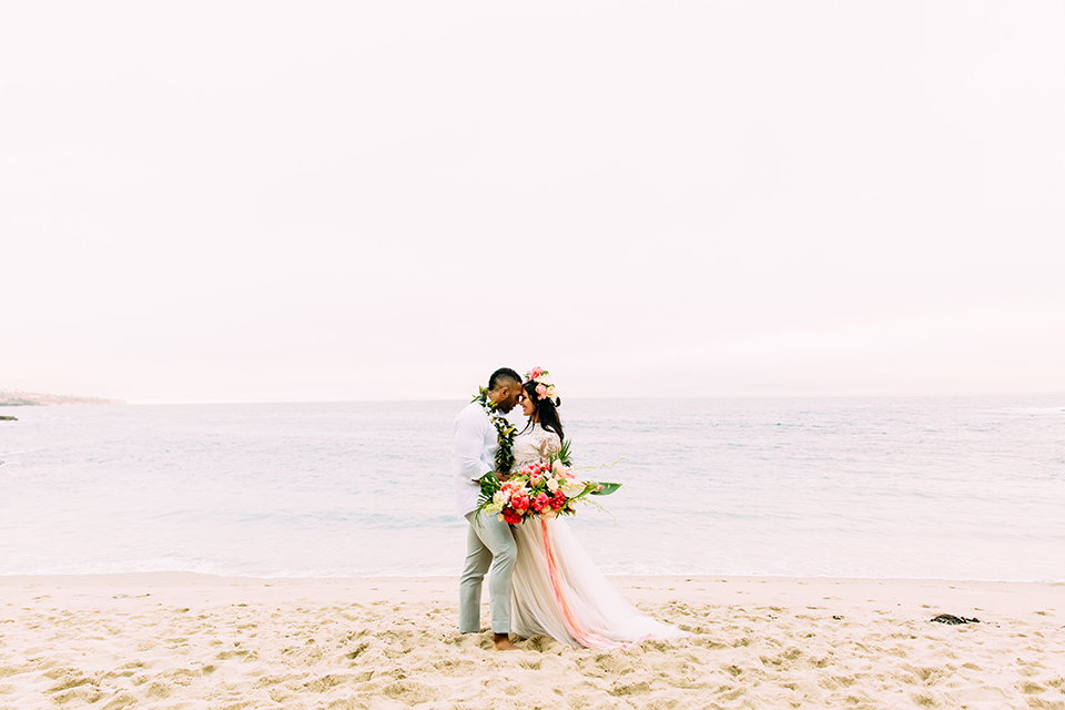 Orange-county-beach-wedding-in-dana-point-bride-and-groom-standing-on-beach-hugging