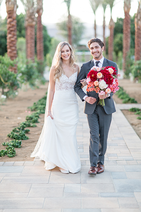 Palm-springs-wedding-shoot-at-old-polo-estate-bride-and-groom-holding-hands-walking