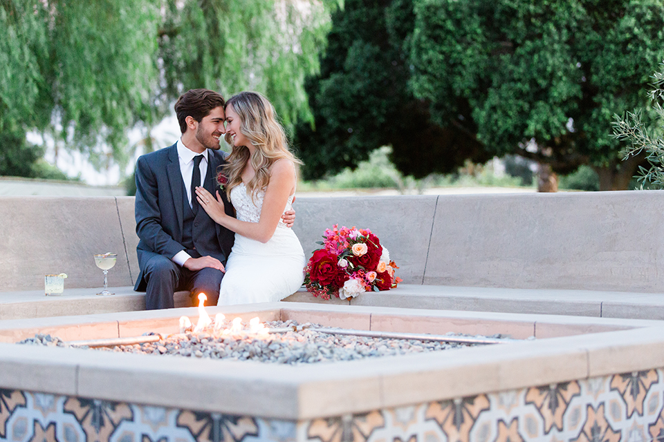 Palm-springs-wedding-shoot-at-old-polo-estate-bride-and-groom-sitting-by-fire