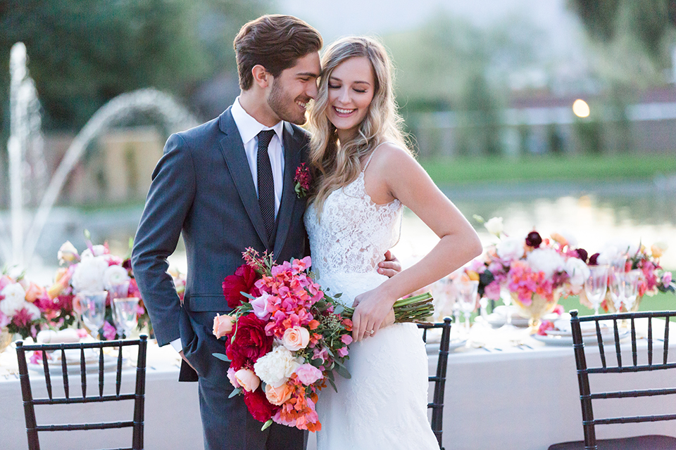 Palm-springs-wedding-shoot-at-old-polo-estate-bride-and-groom-standing-by-table