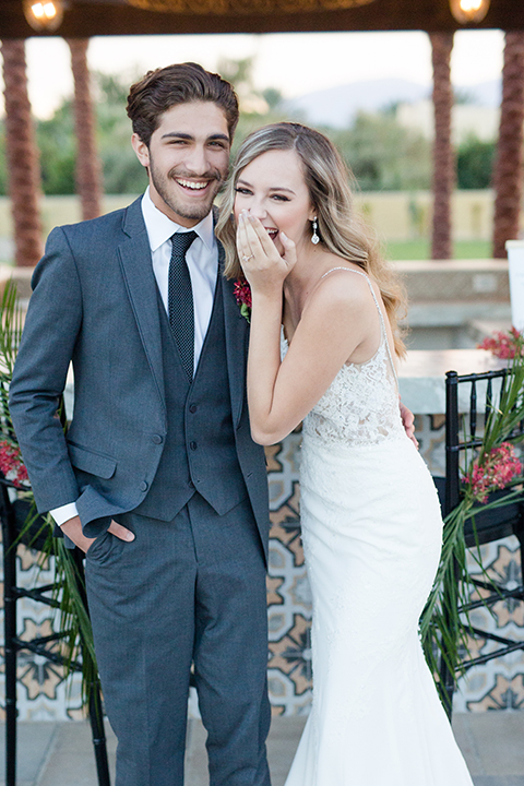 Palm-springs-wedding-shoot-at-old-polo-estate-bride-and-groom-standing-laughing
