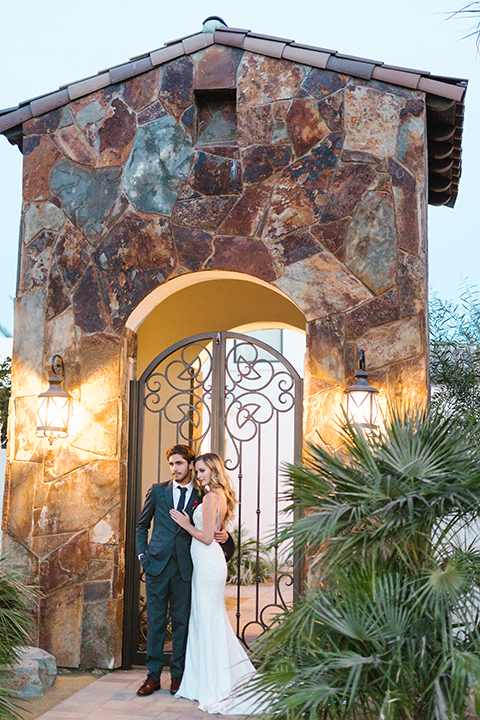 Palm-springs-wedding-shoot-at-old-polo-estate-bride-and-groom-standing-smiling-far-away