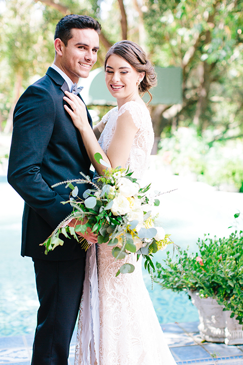 Rancho-las-lomas-outdoor-wedding-bride-and-groom-hugging-smiling