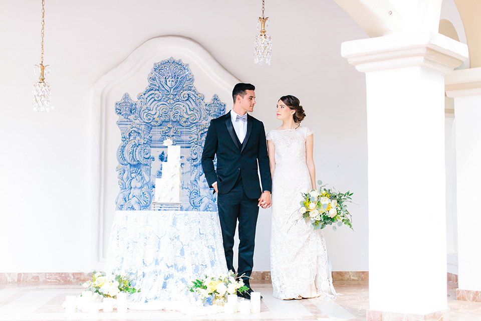 Rancho-las-lomas-outdoor-wedding-bride-and-groom-standing-holding-hands-by-cake