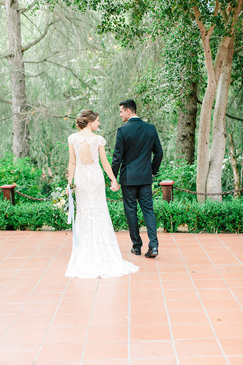 Rancho-las-lomas-outdoor-wedding-bride-and-groom-standing-holding-hands