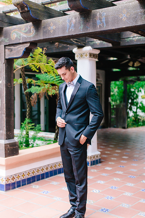 Rancho-las-lomas-outdoor-wedding-groom-black-tuxedo-holding-jacket