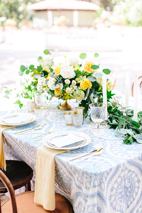 Rancho-las-lomas-outdoor-wedding-table-set-up-with-flowers-and-place-settings