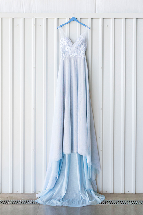  hangar-21-bridal-gown-hanging-blue-dress-with-lace-details-on-the-bodice-and-flowing-light-blue-material-for-the-skirt