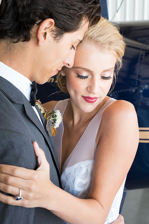 hangar-21-bride-and-groom-close-up-bride-wearing-a-blue-dress-with-lace-details-on-the-bodice-and-flowing-light-blue-material-for-the-skirt-grooom-in-a-charcoal-tuxedo-with-a-matching-charcoal-tie