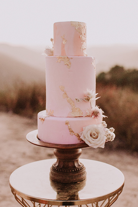 hey-babe-ranch-cake-bride-in-a-bohemian-gown-with-lace-and-fringe-detailing-and-hair-in-a-loose-wave-groom-in-a-burgundy-tuxedo-with-black-satin-truim-and-his-tie-undone-for-a-relaxed-look