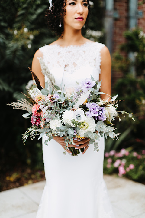 The-Mansion-at-Natirar-bride-holding-flowers-dress-with-a-high-neckline-and-hair-up-groom-in-a-grey-tuxedo-with-black-trim-and-a-black-bowtie