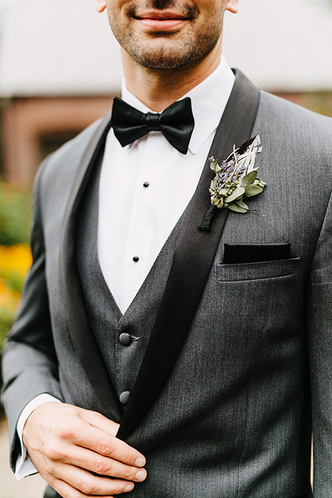The-Mansion-at-Natirar-close-up-on-groom-chairs-groom-in-a-grey-tuxedo-with-black-trim-and-a-black-bowtie
