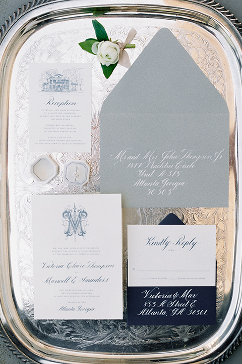 Taylor-Grady-House-shoot-invitations-white-invitations-with-a-dusty-blue-color-to-match-the-accents-of-the-wedding-décor-all-displayed-on-a-mirrored-plate