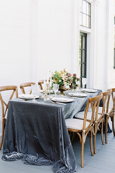 Taylor-Grady-House-shoot-table-decor-set-up-wooden-chairs-with-a-dusty-blue-velvet-table-linnen-and-simple-white-décor