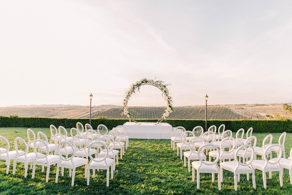 callaway-winery-shoot-ceremony-set-up-white-chairs-with-a-circular-arch-with-light-florals