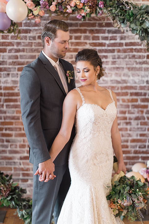 Orange-county-whimsical-wedding-at-franciscan-gardens-bride-and-groom-holding-hands