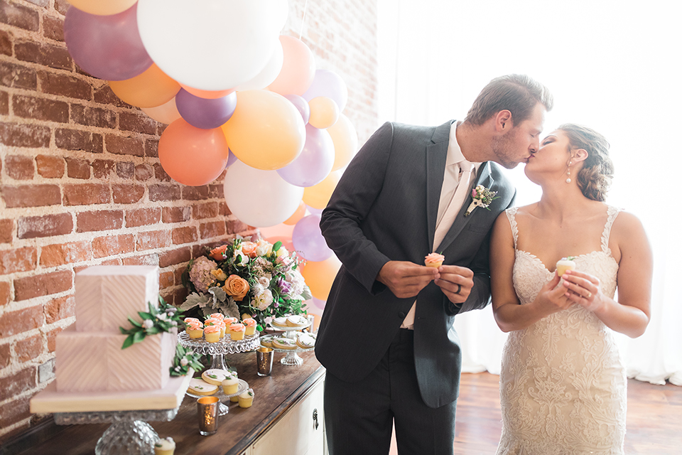 Orange-county-whimsical-wedding-at-franciscan-gardens-bride-and-groom-standing-kissing