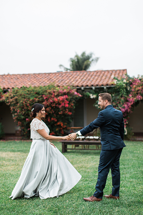 San-diego-outdoor-wedding-at-the-inn-at-rancho-santa-fe-bride-and-groom-holding-hands-smiling