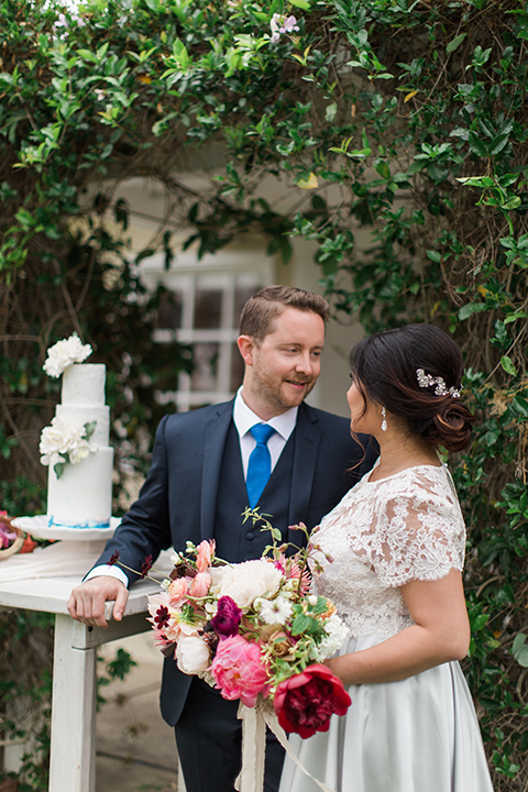 San-diego-outdoor-wedding-at-the-inn-at-rancho-santa-fe-bride-and-groom-standing-cake