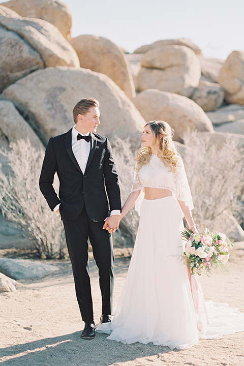 Joshua-tree-wedding-shoot-at-the-ruin-venue-bride-and-groom-holding-hands