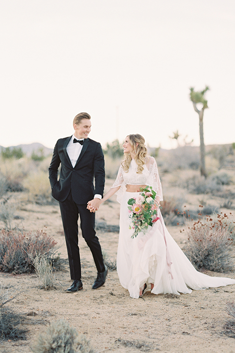 Joshua-tree-wedding-shoot-at-the-ruin-venue-bride-and-groom-standing-holding-hands