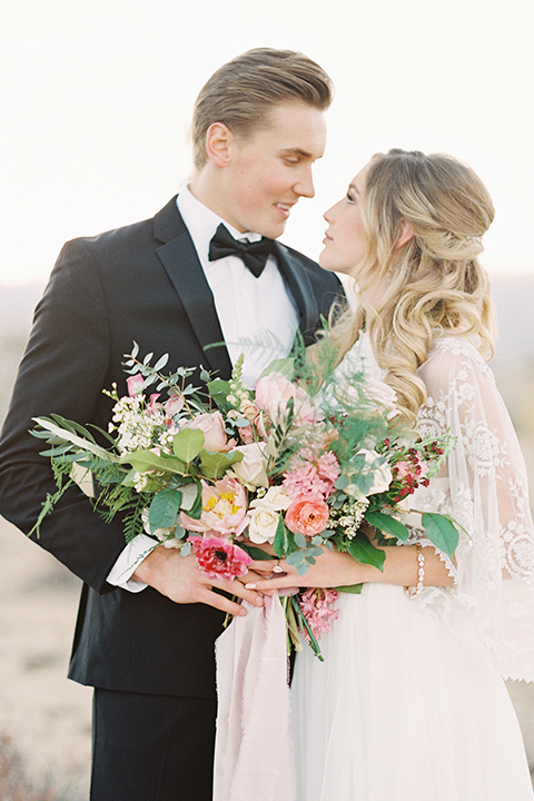 Joshua-tree-wedding-shoot-at-the-ruin-venue-bride-and-groom-standing-hugging-close-up