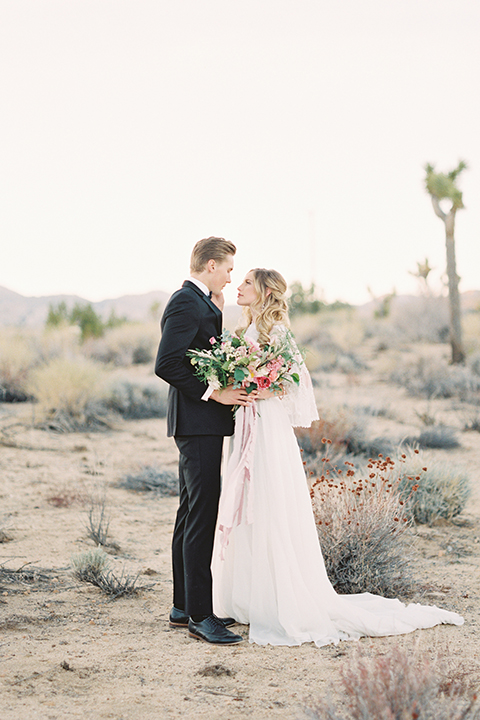 Joshua-tree-wedding-shoot-at-the-ruin-venue-bride-and-groom-standing-hugging